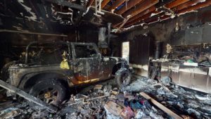 burned car in a garage