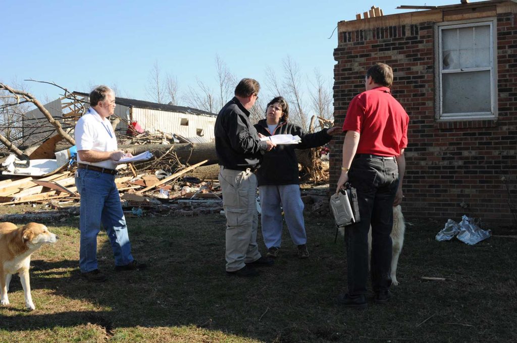 Lafayette, TN., February 8, 2008 -- The State/FEMA Preliminary Damage Assessment Team is talking with this homeowner about damage they received from the recent tornado. FEMA PDA Inspector Matt Sackwitz(right), State PDA Inspector Richard Taylor(center) and SBA Inspector Dennis Ayers will compile data to determine an estimate of cost to recover from this disaster. George Armstrong/FEMA